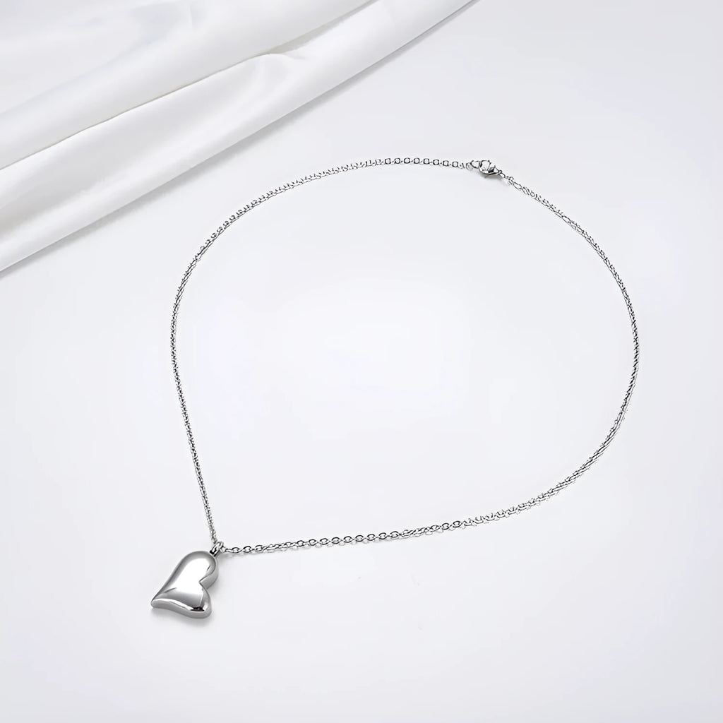 Silver curved peach heart pendant on stainless steel necklace chain with extension