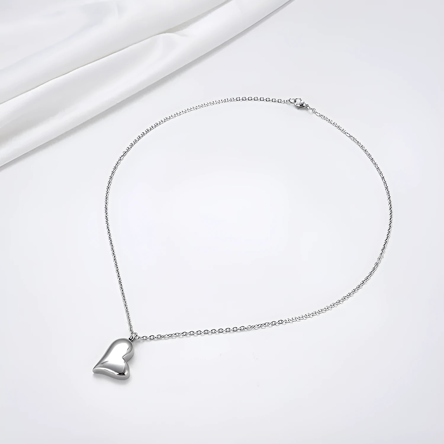 Silver curved peach heart pendant on stainless steel necklace chain with extension