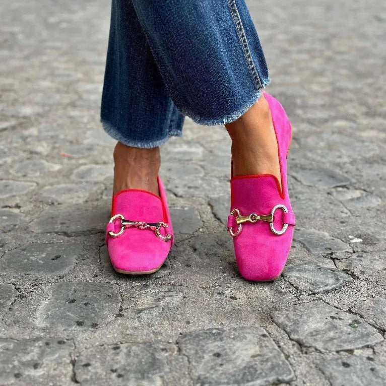 Green suede women's loafers with a round toe and silver metal fastener buckle on a flat rubber sole.