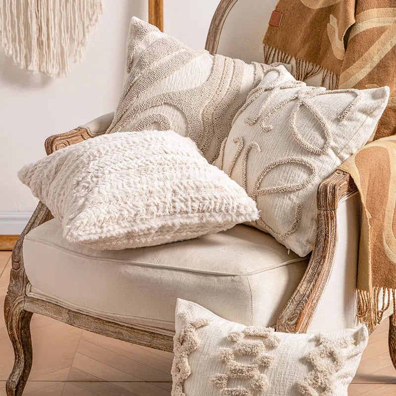Knitted striped cushion cover with tassel trim in 45x45cm size on a sofa.
