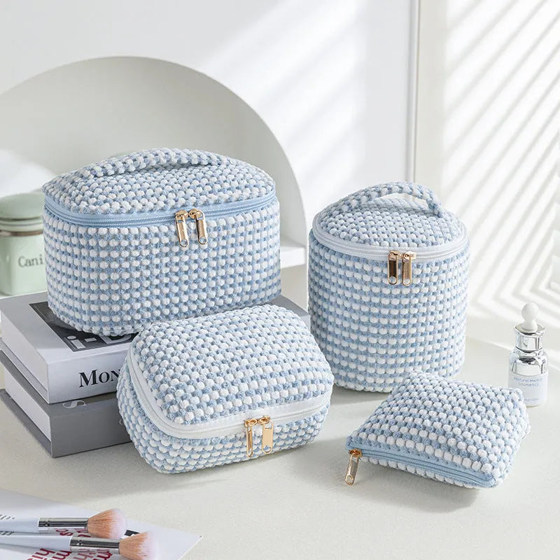 Four cube-style polyester makeup bags in pink, khaki, pink dots, and blue with dots colour options