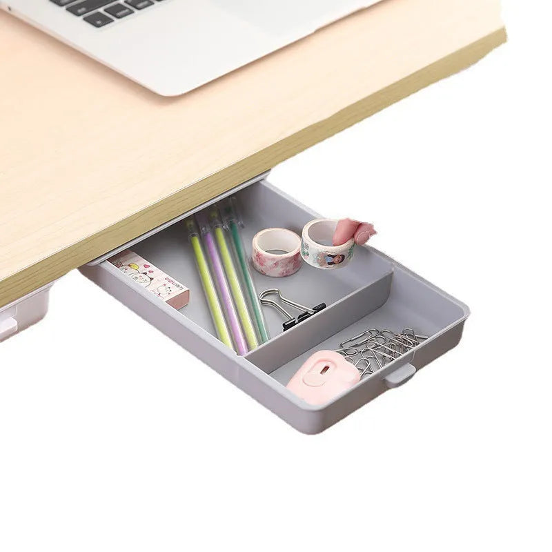 Small white plastic storage box with a grid pattern, shown adhered underneath a wooden table.