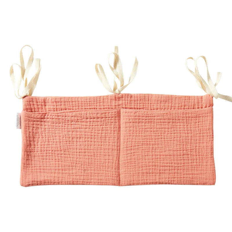 Cotton double layer baby bedside buggy bag in camel colour with tie straps attached to a pram handle