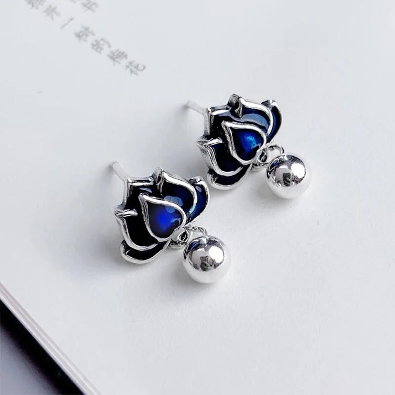 Blue lotus seedpod tassel stud earrings with flower shape, measuring 1.2cm wide.
