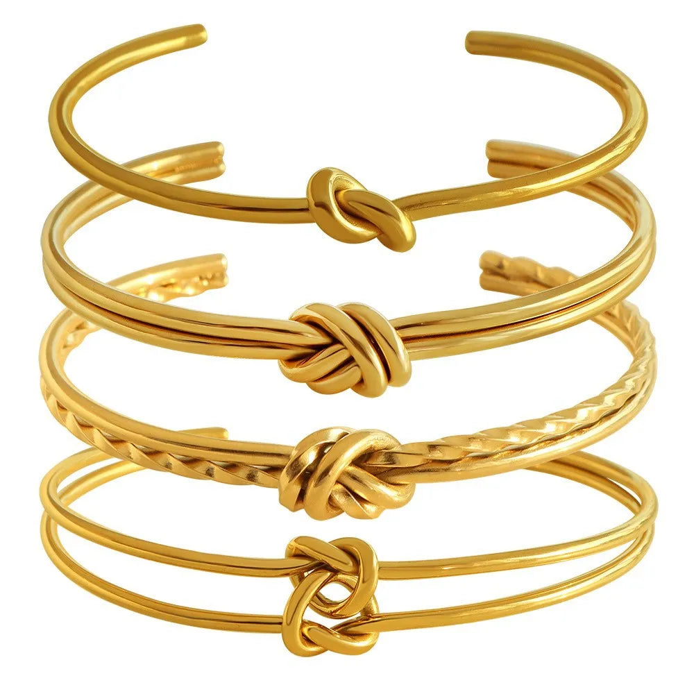 Women's open C-shape knotted double-layer bracelet in gold or silver plating on a wrist.