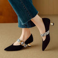Black French pointed stiletto high heels for women with a buckle strap closure.