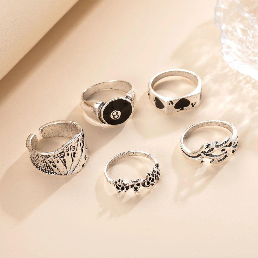 Black alloy poker ring with a large spade design and adjustable band.