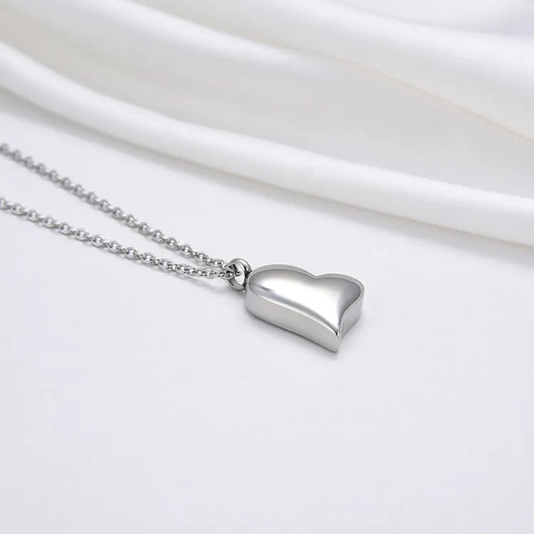 Silver curved peach heart pendant on stainless steel necklace chain with extension