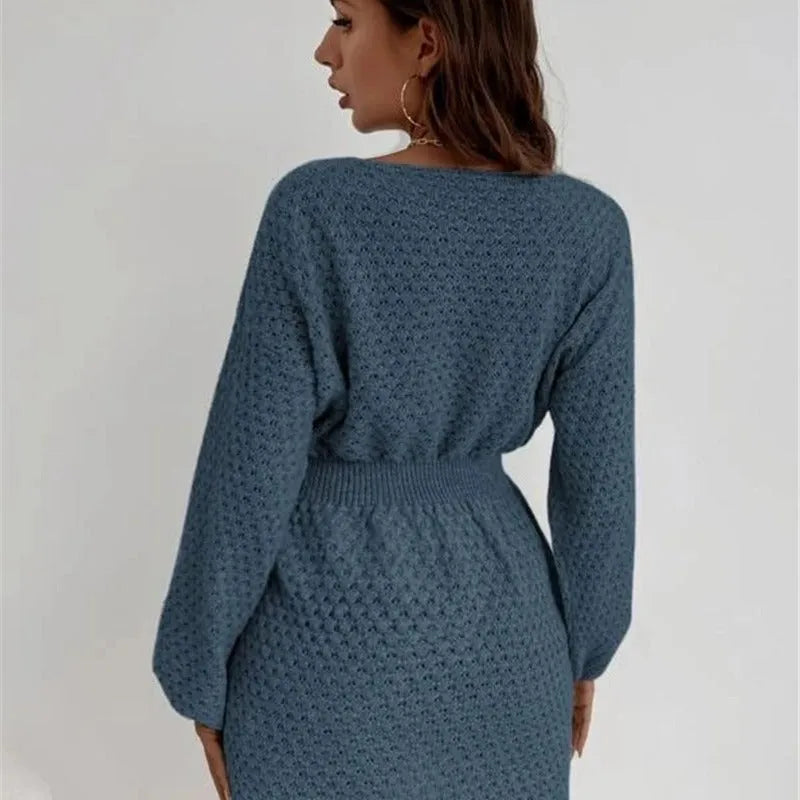 Blue women's knitted dress with hand-crocheted white flowers, a fitted waist, and a round neck.