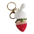 Hand-woven white wire pendant with rabbit and strawberry cartoon pattern, shown with a key attachment.