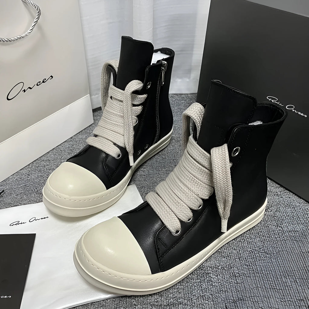 Black high-top leather sneakers with side zipper and platform sole on a white background