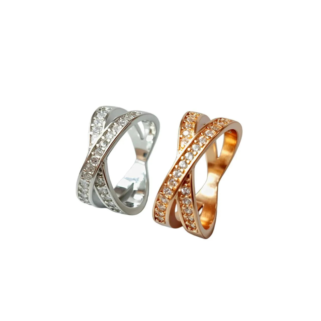 Simple metal cross ring with micro-inlaid zircon on a geometric band, shown in silver and rose gold finishes.