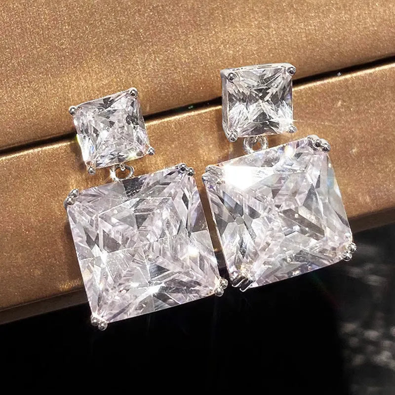 A pair of copper geometric square earrings for women, shown in white gold and golden colour options.