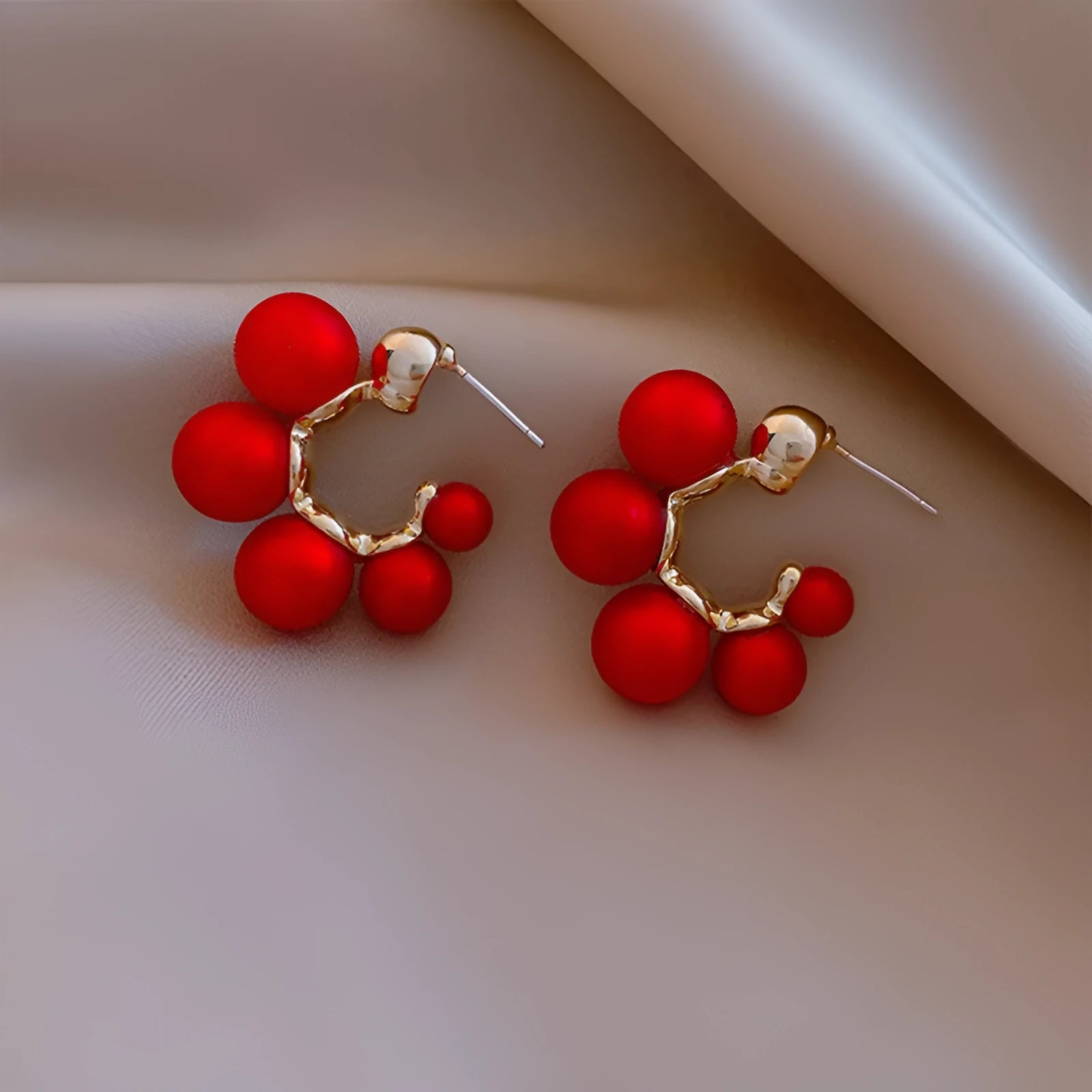 Red bell-shaped alloy drop earrings for women on a white background.