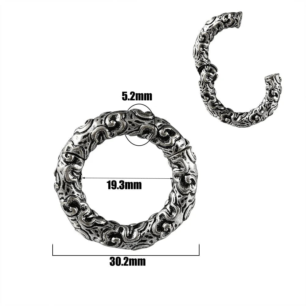 A pair of stainless steel totem pattern earrings with an electroplated finish, shown from the 15 available style options.