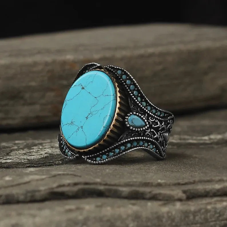 Men's antique silver alloy round band ring showing simple turquoise colour on finger