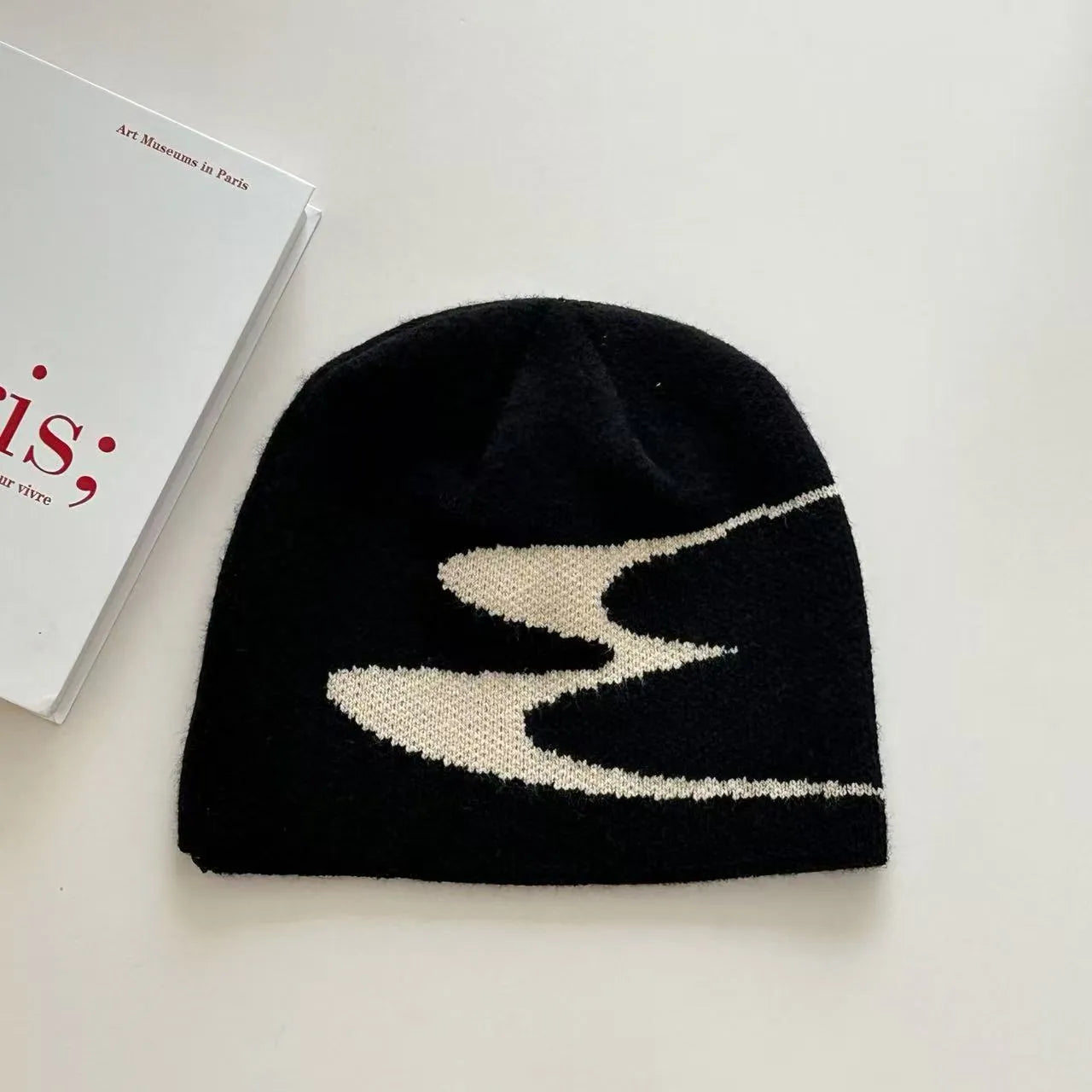 Medium-sized acrylic beanie hat for men and women in black colour showing knit texture
