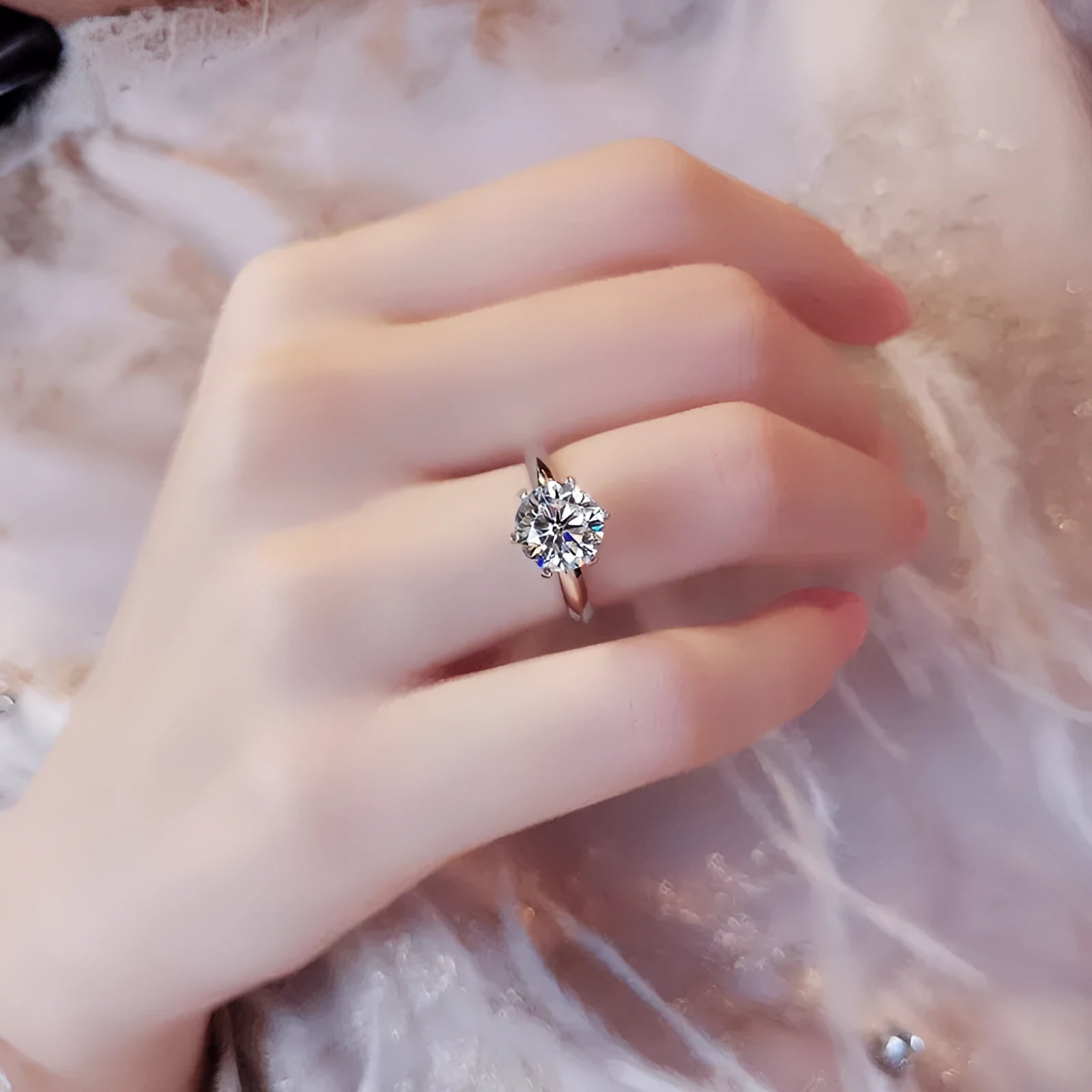 White gold plated six-claw zircon women's ring with geometric shape on a finger.