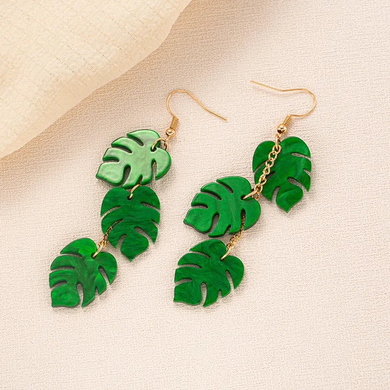 Drop shaped alloy and acrylic ear hook earrings with coconut summer design in multiple colours.
