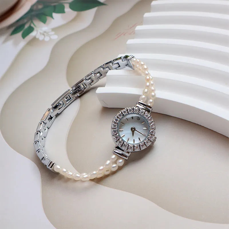 Women's light gold freshwater pearl bracelet watch with round dial and stainless steel strap