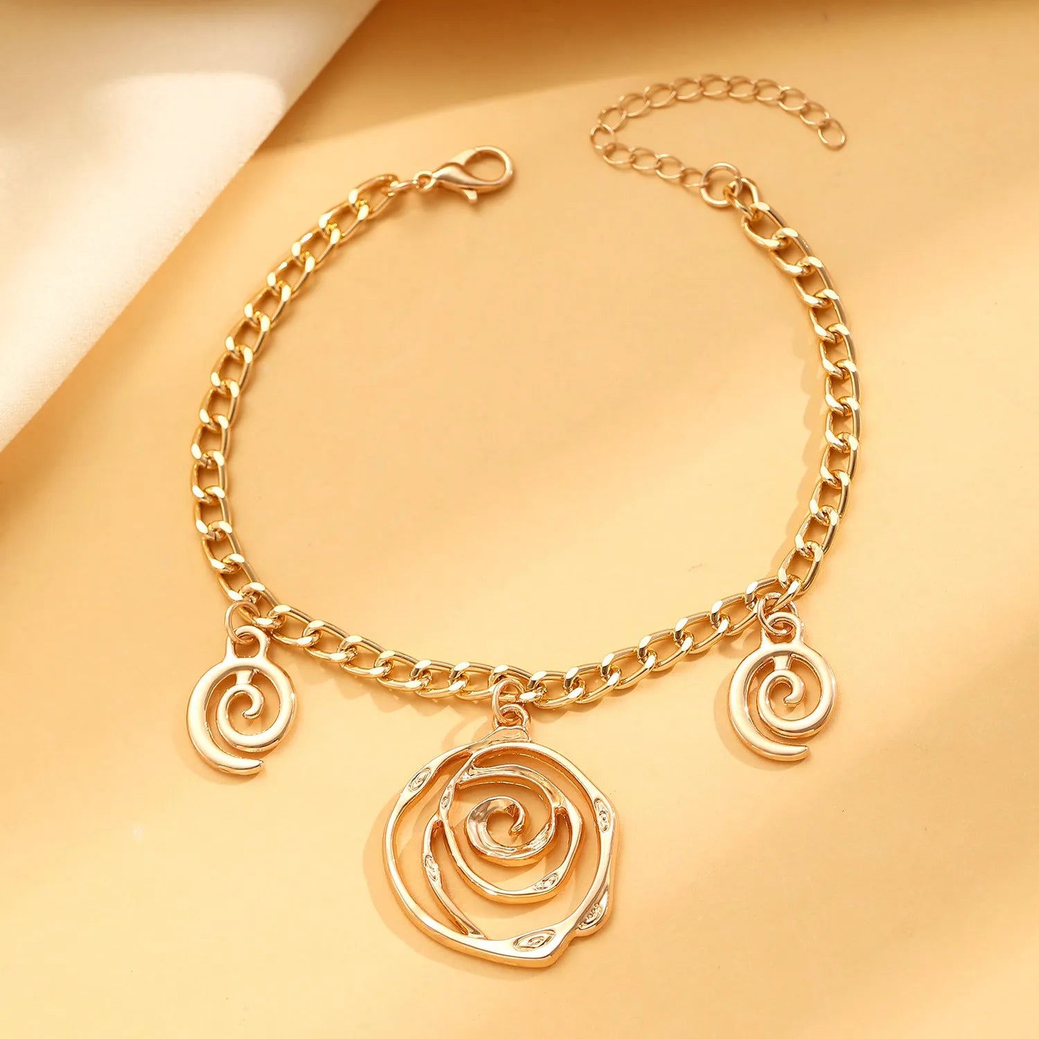 Spiral donut design alloy necklace, bracelet and earrings set in gold or silver electroplated finish.