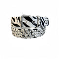 Women's punk fashion belt with metal pyramid studs in leopard print pattern, showing alloy buckle and PU leather strap.