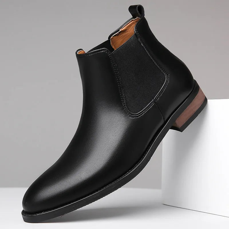 Men's black and light brown pointed toe Chelsea boots with a high-top design and rubber sole.