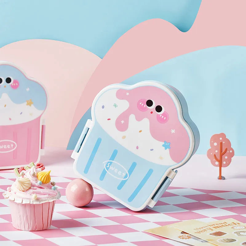 Creative blue and pink ice cream shaped plastic lunch box with spoon and fork on a table