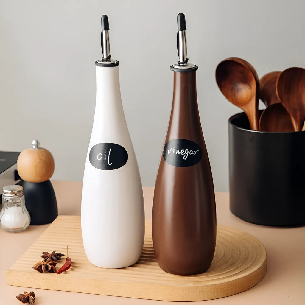 Ceramic oil pot with funnel in black, coffee, and white colour options, 650ml capacity.