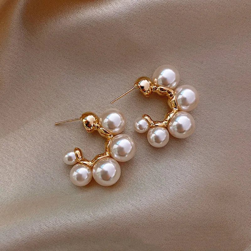 Red bell-shaped alloy drop earrings for women on a white background.