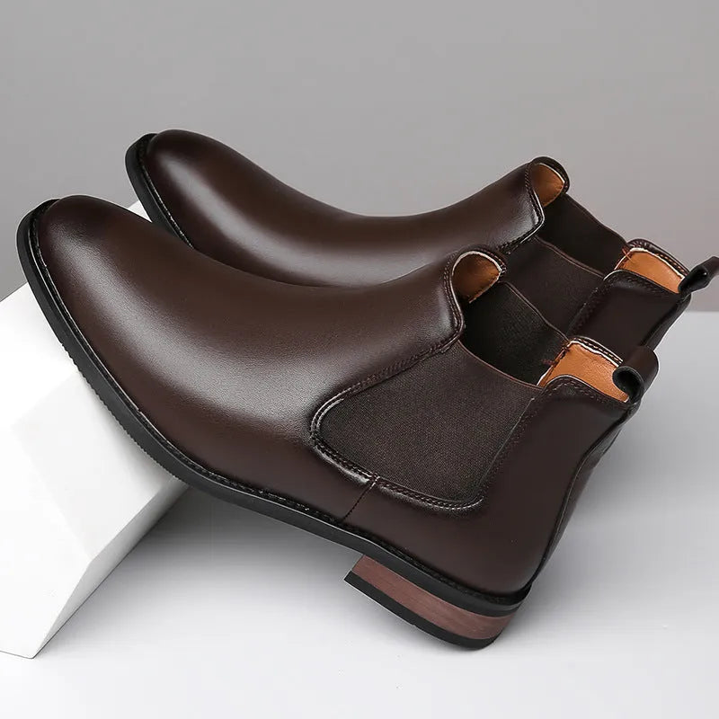 Men's black and light brown pointed toe Chelsea boots with a high-top design and rubber sole.