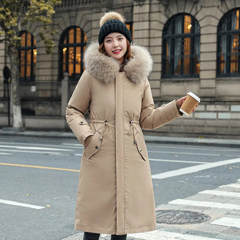 Long beige women's trench coat with cotton-padded fleece construction on a hanger.