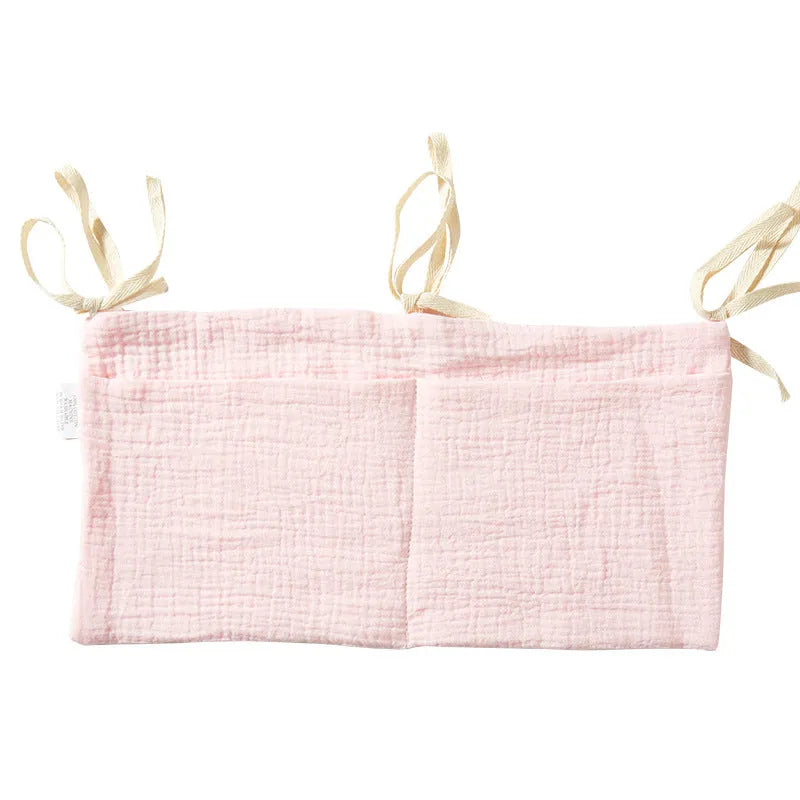 Cotton double layer baby bedside buggy bag in camel colour with tie straps attached to a pram handle