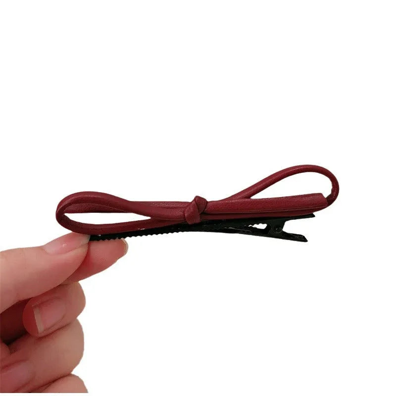 Wine red leather bow hair barrette showing handmade bow design detail