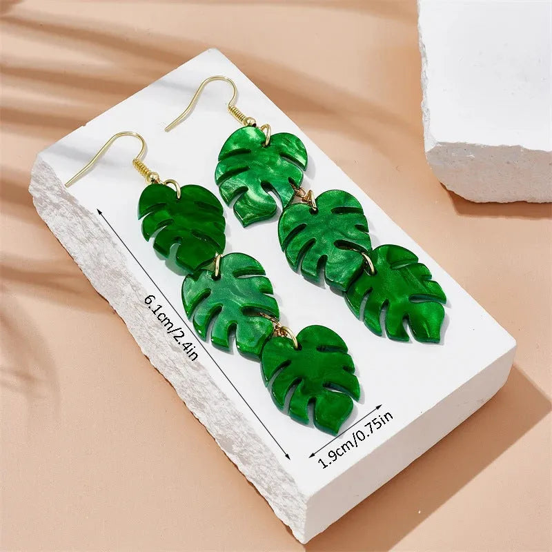 Drop shaped alloy and acrylic ear hook earrings with coconut summer design in multiple colours.