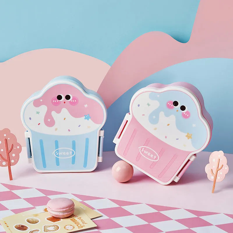 Creative blue and pink ice cream shaped plastic lunch box with spoon and fork on a table