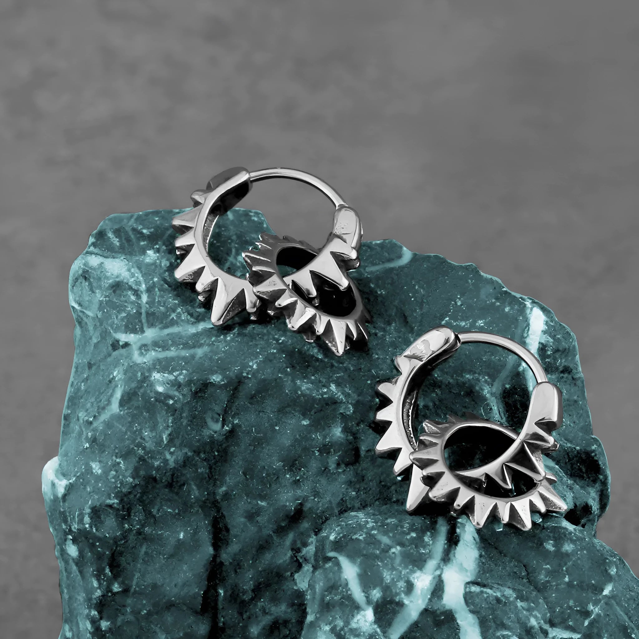 A pair of simple stainless steel round ring earrings with a polished steel colour finish.