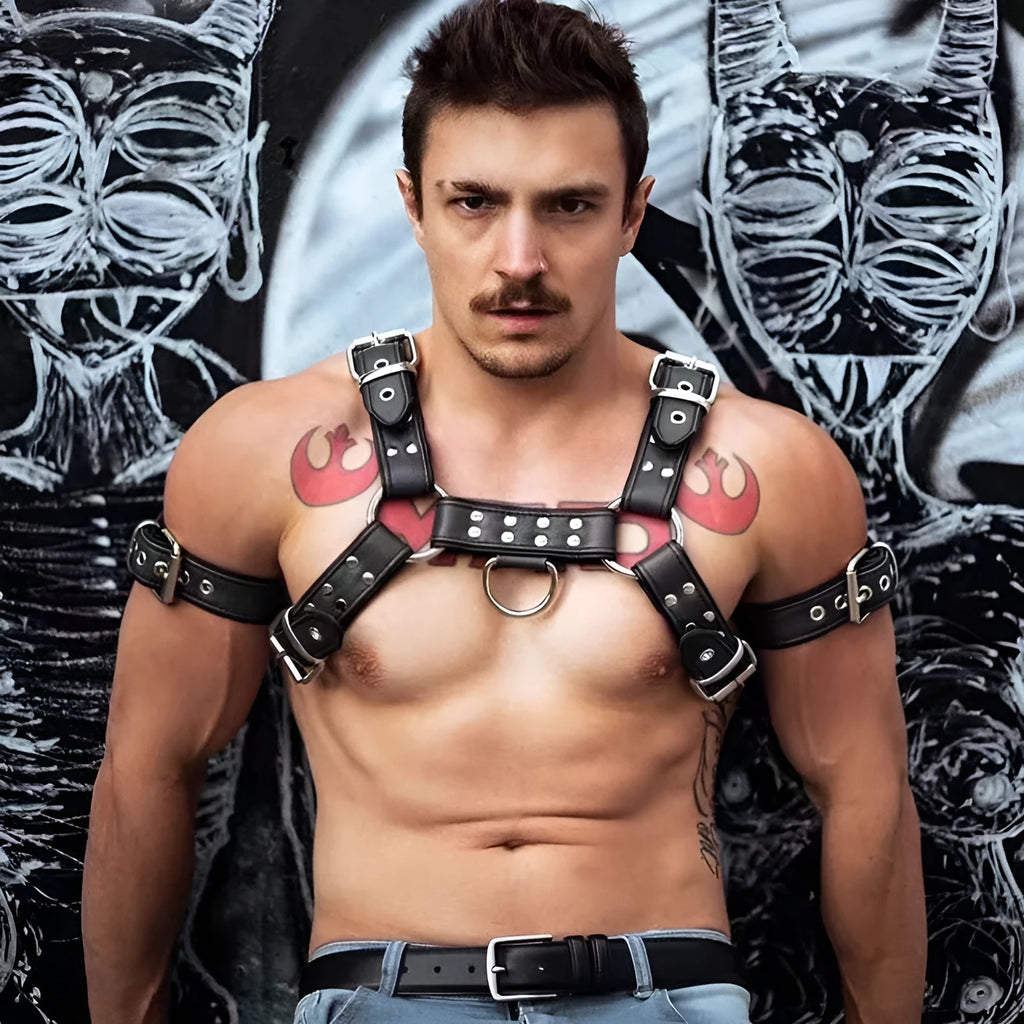 Black leather chest bondage strap with metal buckle and rivet details for adult costume use.