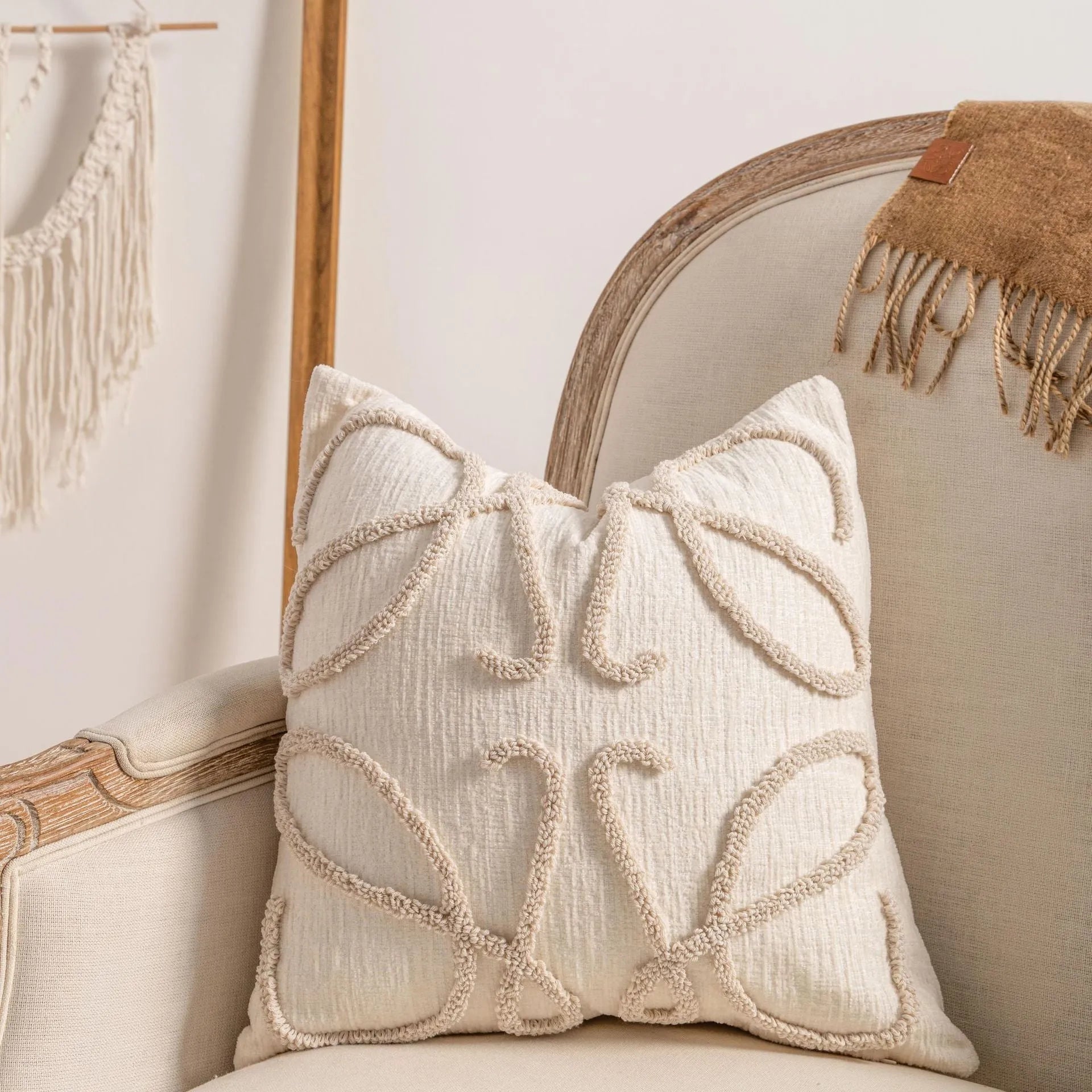 Knitted striped cushion cover with tassel trim in 45x45cm size on a sofa.