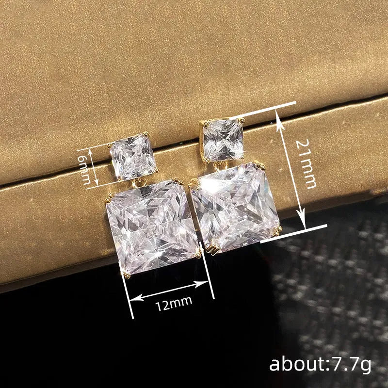 A pair of copper geometric square earrings for women, shown in white gold and golden colour options.
