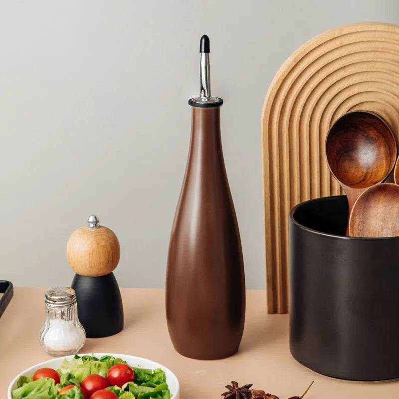 Ceramic oil pot with funnel in black, coffee, and white colour options, 650ml capacity.