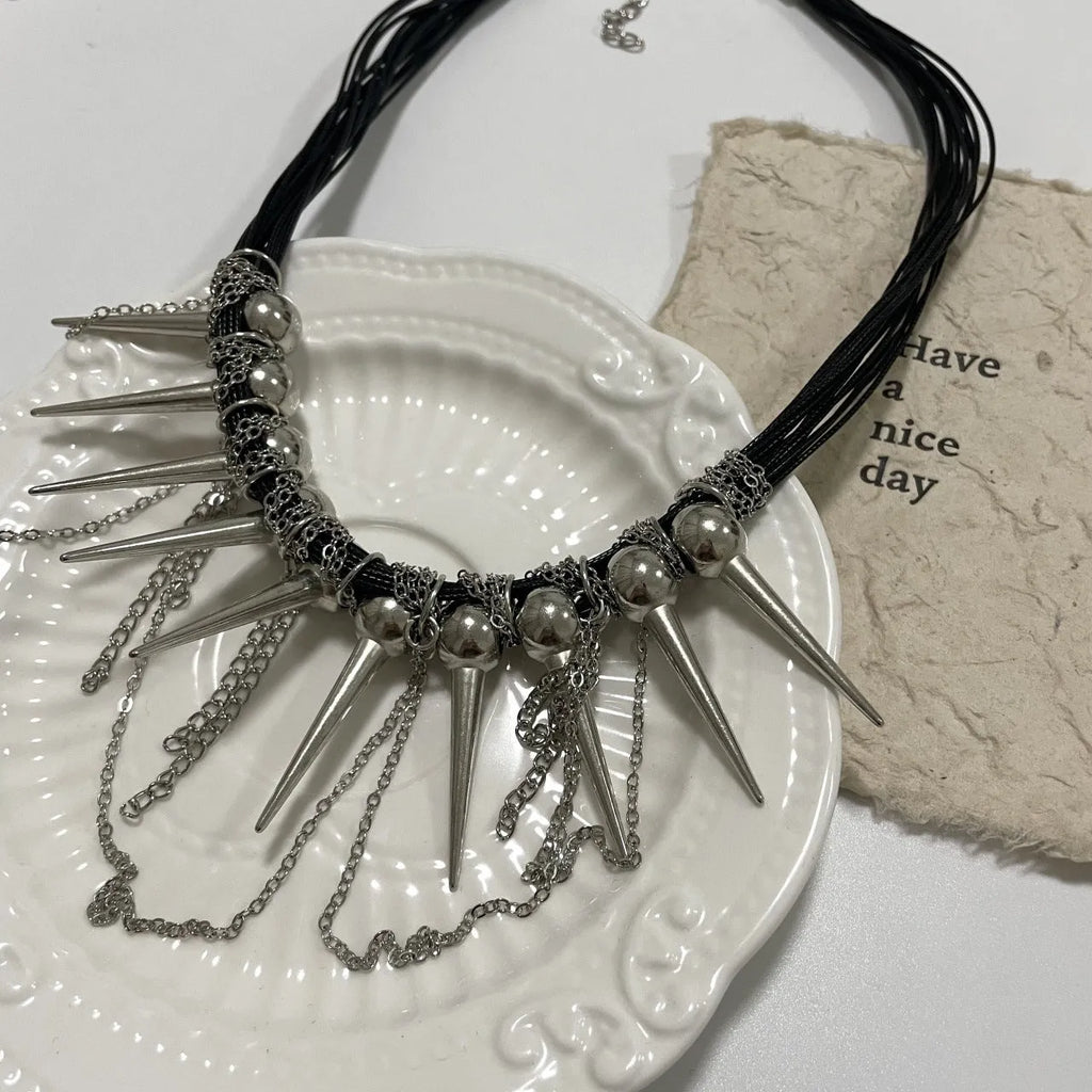 Women's casual leather necklace with electroplated round beads, rivet detailing, and winding tassel design