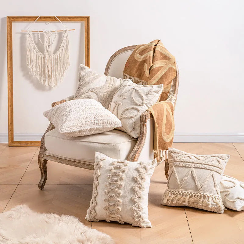 Knitted striped cushion cover with tassel trim in 45x45cm size on a sofa.