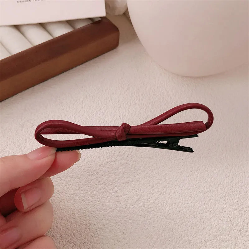 Wine red leather bow hair barrette showing handmade bow design detail