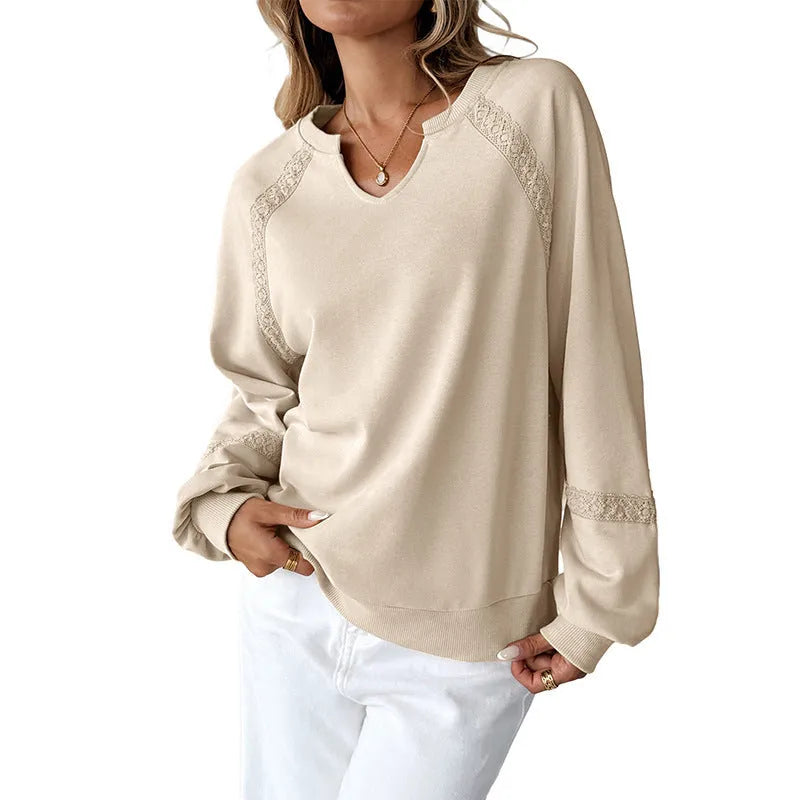 Women's solid colour sweater with a half-open collar featuring white stitching lace detail and long sleeves.