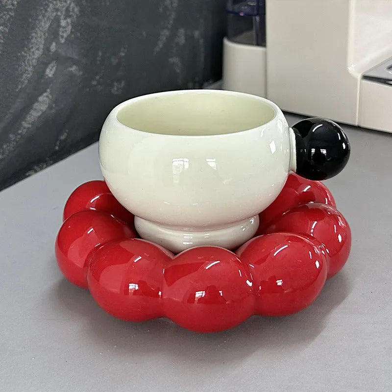 Ceramic coffee cup and saucer set in a simple solid colour, showing the 250ml cup resting on its matching dish.
