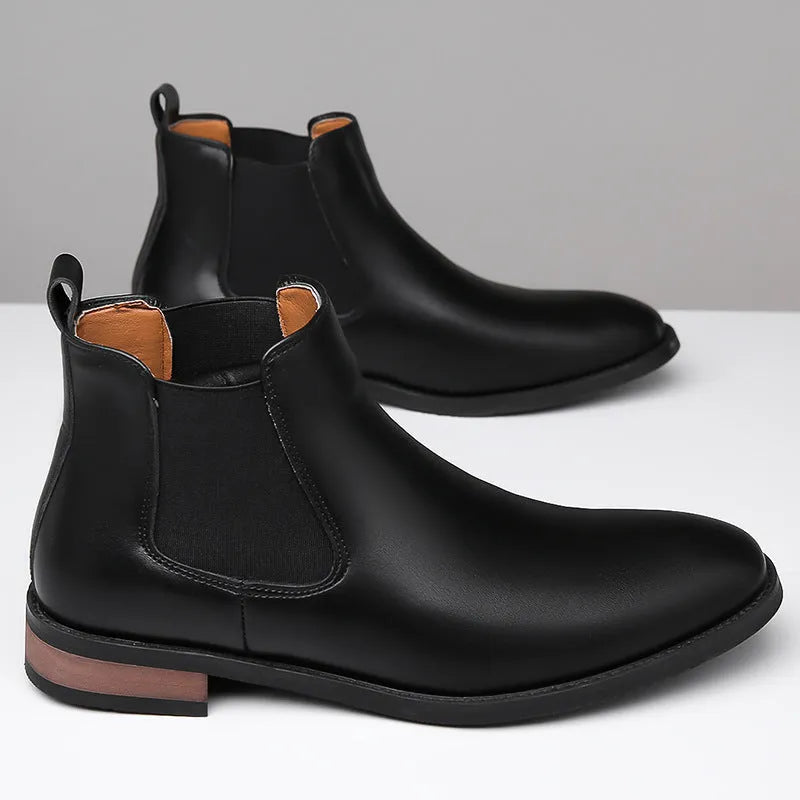 Men's black and light brown pointed toe Chelsea boots with a high-top design and rubber sole.