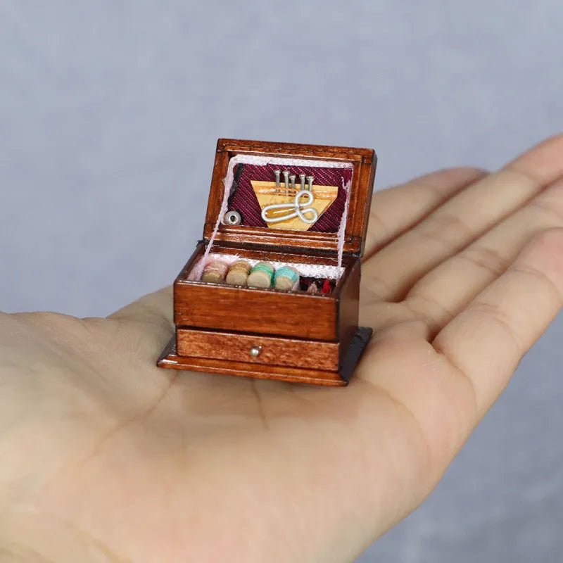 Miniature wooden vintage sewing machine sewing kit with double layer colour design on a white background.