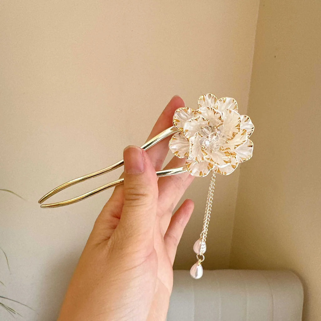 Close-up of a retro-style alloy U-shaped hairpin with a detailed purple peony flower and tassel design.
