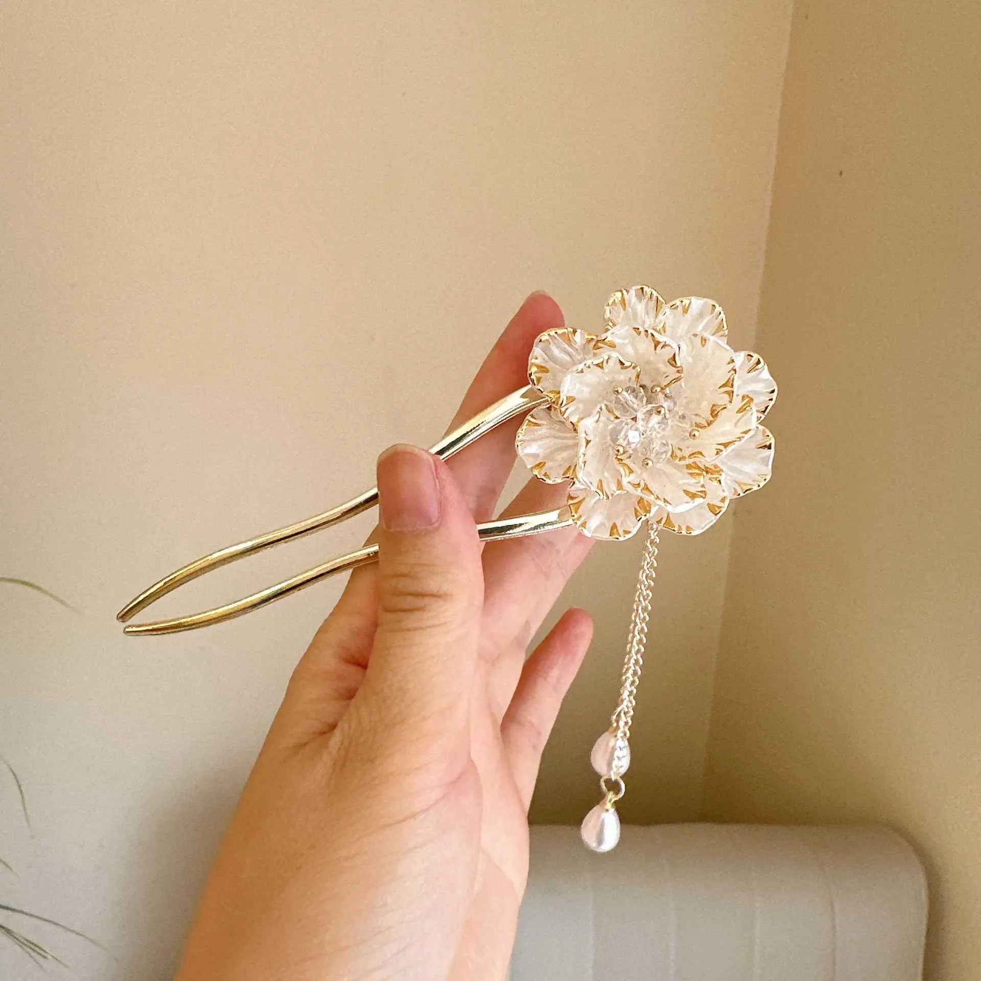 Close-up of a retro-style alloy U-shaped hairpin with a detailed purple peony flower and tassel design.